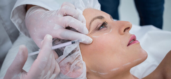 Woman receiving botox injection at clinic